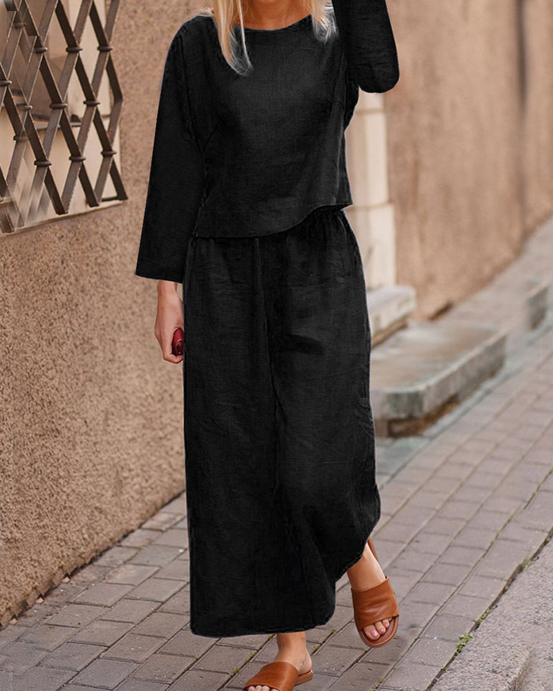 Black long-sleeve two-piece set: layered top and wide-leg pants