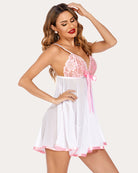 White lace babydoll with pink bow, thin straps, and flared mesh skirt