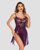 Purple lace babydoll dress with thin straps, corset-style bodice, and flowing sheer skirt