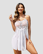 White lace babydoll dress with thin straps, scalloped lace bodice, and layered sheer skirt