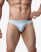 Men's low-rise briefs in light blue on model with elastic waistband