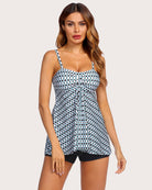 Two-piece tankini set with white tank printed in blue and green circles and black swim shorts