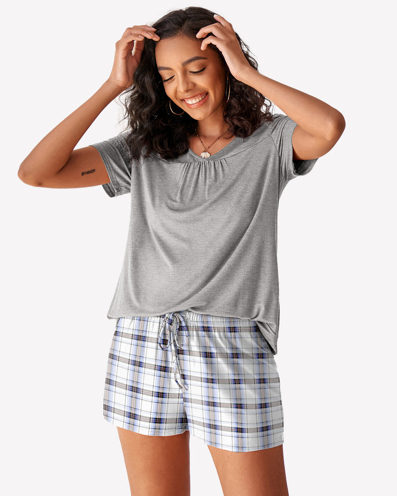 Grey short-sleeve pajama top with blue-and-white plaid drawstring shorts