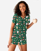 Green Christmas pajama set with gingerbread and snowman print; short-sleeve top