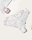 White lace thong panties with crisscross strap detail and scalloped edges