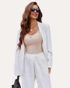 Beige ribbed camisole tank top with lace trim and bow at neckline