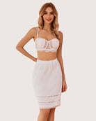 White knee-length skirt with elastic waistband and lace trim at hem