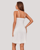 White full slip dress with lace-trim hem; V-back and thin spaghetti straps