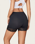 Black shapewear shorts with lace trim at leg openings and contoured rear fit.