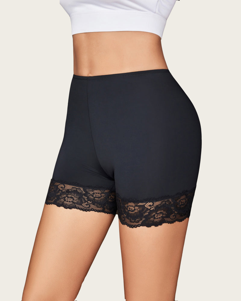 Black shaping shorts with lace hem detail and smooth compression fabric.