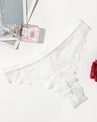 White lace T-back thong laid flat with bow at front