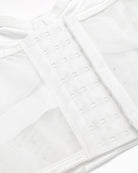 White corset bustier close-up of hook-and-eye closure and mesh front panel