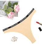 Low-rise thong panties, pale yellow-beige, black AVIDLOVE logo waistband.