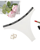 Low-rise thong panties, white, black AVIDLOVE logo waistband.