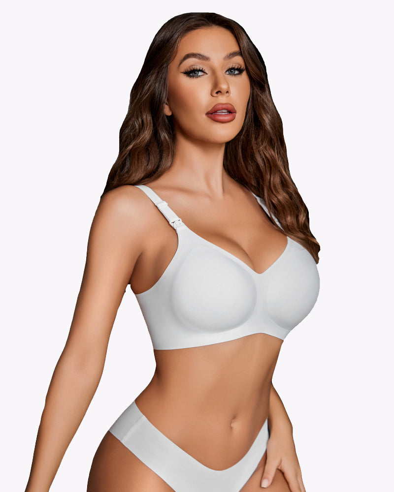 White seamless nursing bra with molded cups and adjustable straps, 3/4 front view.