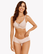 Nude wireless nursing bra on model with adjustable straps and front nursing cup