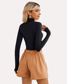 Black high-neck snap-closure soft bodysuit with long sleeves and sleek neckline