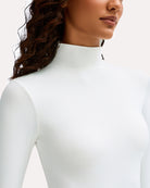 White high-neck long-sleeve soft bodysuit neckline close-up