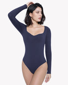 Dark navy sweetheart-neck bodysuit shapewear with long sleeves, side pose