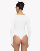 White sweetheart-neck bodysuit, long sleeves, back view with high-cut legs