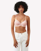 Light pink lace unlined strappy bra with bow detail at center and underwire cups