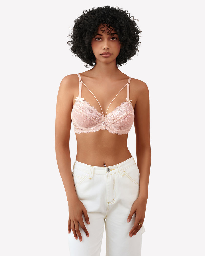 Light pink lace unlined strappy bra with bow detail at center and underwire cups