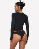 Black long-sleeve V-neck top with matching high-leg panties set, back view