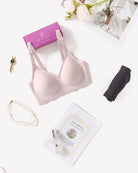 Light pink seamless wireless bra with adjustable straps, shown with packaging