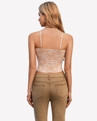 Beige lace cami top back view with spaghetti straps and corset-style seams