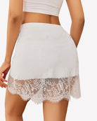 White lace half slip skirt with elastic waistband and scalloped hem, sheer lace band detail.