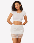 White lace half slip skirt with elastic waistband and scalloped lace hem, layered underskirt.