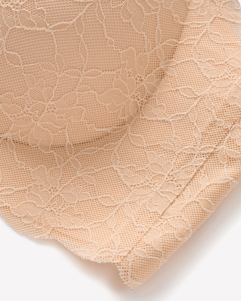 Nude lace bra fabric close-up with floral texture and mesh-like overlay