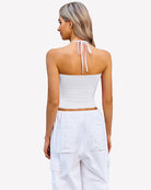 Ruched halter crop top in white with tied neck straps and ruched back
