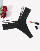 Black lace thong panties with scalloped lace trim and V-waist strappy design