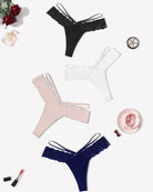 Lace thong panties set: black, white, blush, and navy V-waist straps with scalloped trim