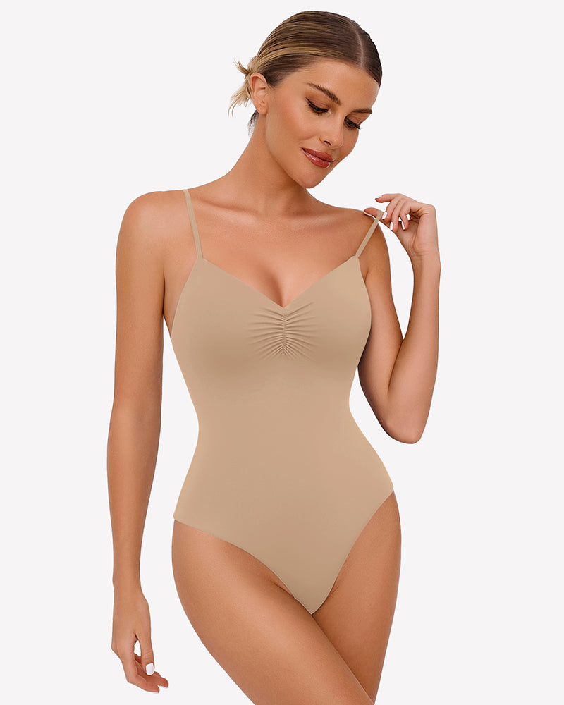 Beige ruched V-neck thong bodysuit with thin spaghetti straps.