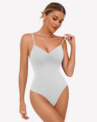 Ruched V-neck thong bodysuit in white, with spaghetti straps and gathered bust