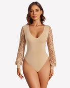 Beige lace puff-sleeve leotard with deep V neckline and sheer lace sleeves