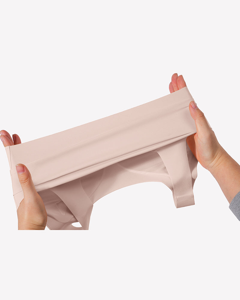 Wireless seamless no-underwire bra band and seamless fabric in light nude, stretched close-up