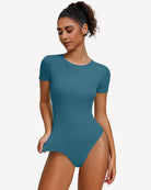 Teal short-sleeve snap bodysuit, scoop neck, fitted one-piece leotard.