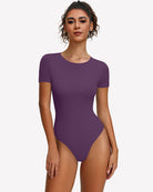 Purple short-sleeve snap bodysuit, scoop neck, fitted one-piece leotard.
