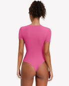 Short-sleeve snap bodysuit, bright pink back view with smooth fitted silhouette and thong-style back.