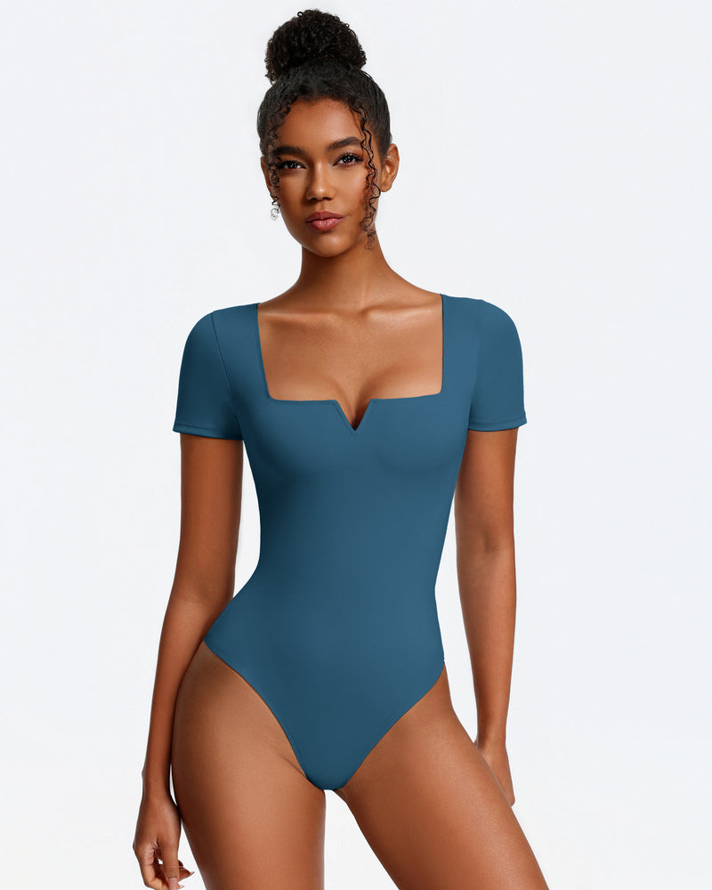 Blue short-sleeve square-neck bodysuit, fitted one-piece with thong bottom.