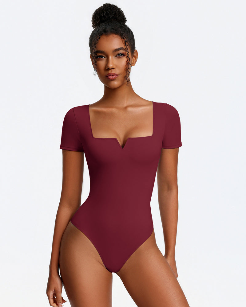 Burgundy short-sleeve square-neck bodysuit, fitted one-piece with thong bottom.