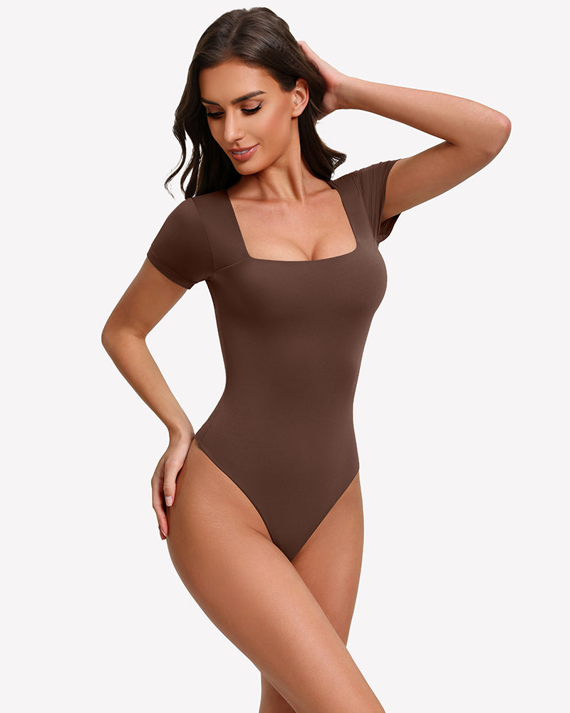 Square-neck short-sleeve bodysuit in dark brown, fitted one-piece with thong-style leg openings.
