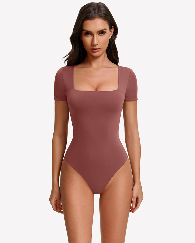 Square-neck short-sleeve bodysuit in rose-brown, fitted one-piece with thong-style legs.