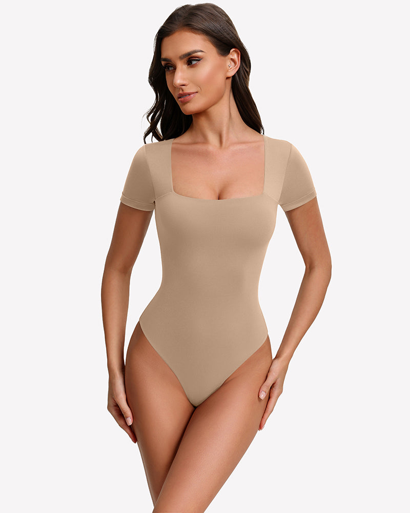 Square-neck short-sleeve bodysuit in nude-beige, fitted one-piece with thong-style leg openings.