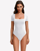 Square-neck short-sleeve bodysuit in white, fitted one-piece with thong-style leg openings.