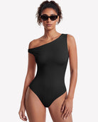 Black off-shoulder asymmetric bodysuit with one-shoulder neckline and fitted leg openings