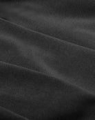 Close-up of black woven fabric with fine texture.